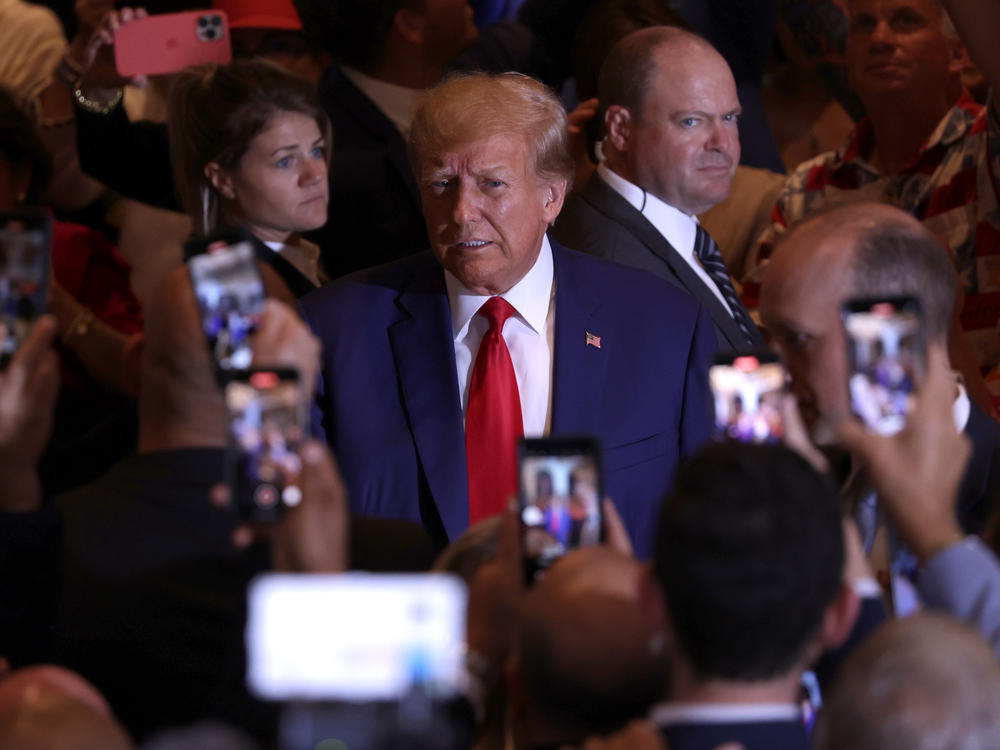 Former President Donald Trump arrives at an event Tuesday evening at his Mar-a-Lago estate in Palm Beach, Fla., after pleading not guilty in New York to 34 felony counts.