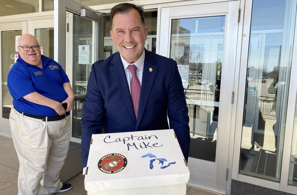 Republican Mike Brown, a state police official, prepares to turn in nominating petitions to run for governor on April 12, 2022, outside the Michigan Department of State in Lansing. The next month, Brown withdrew from the race after his campaign was caught up in alleged signature fraud.