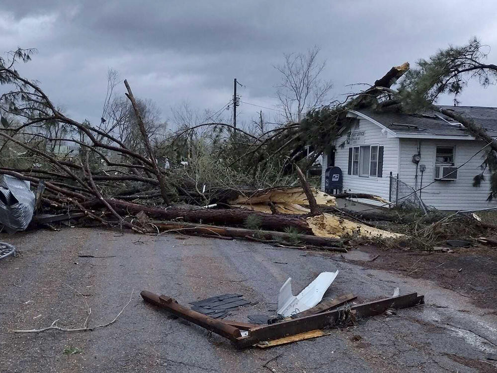 Debris covers the ground as homes are damaged after severe weather in Glen Allen, Mo., on Wednesday.