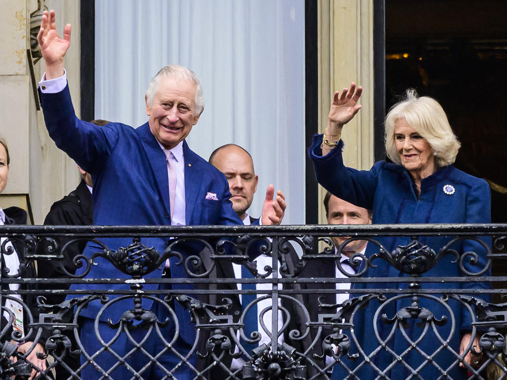 King Charles and Camilla, queen consort, greet well-wishers from the balcony of Hamburg's city hall in Germany on March 31. It was Charles' first state visit as king.