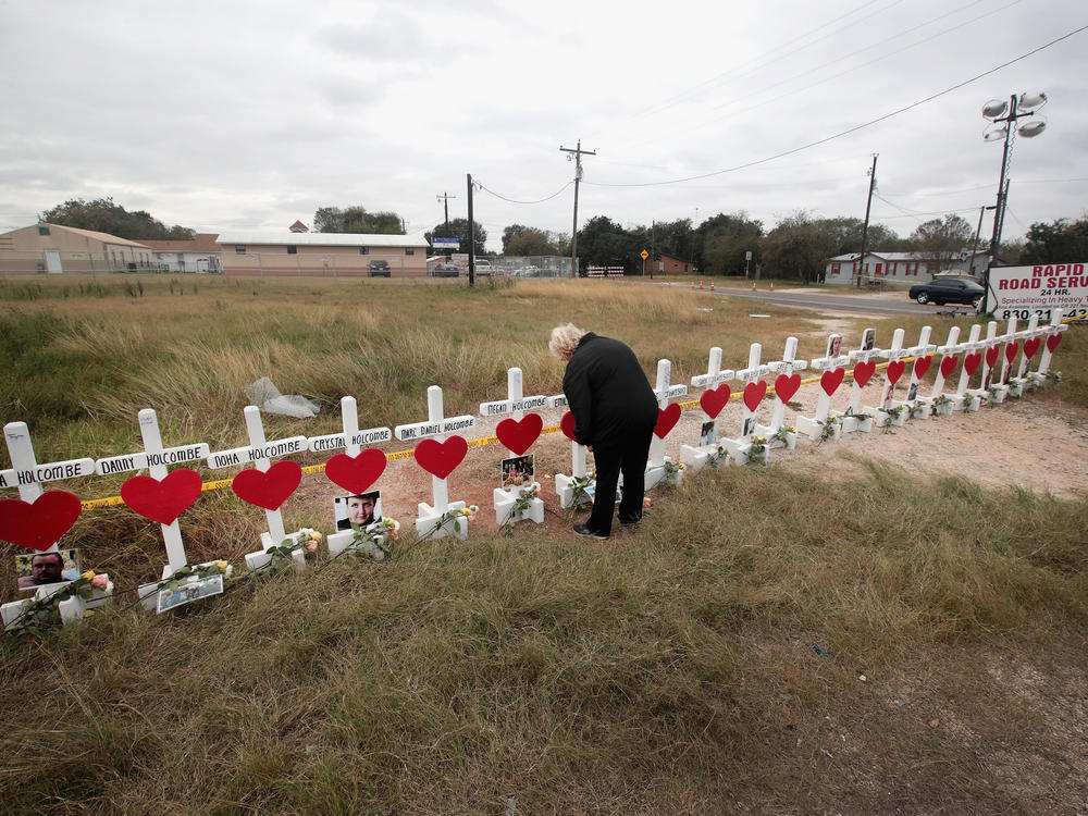 Helen Biesenbach leaves a message at a memorial where 26 crosses were placed to honor the victims killed at the First Baptist Church of Sutherland Springs on November 9, 2017 in Sutherland Springs, Texas.