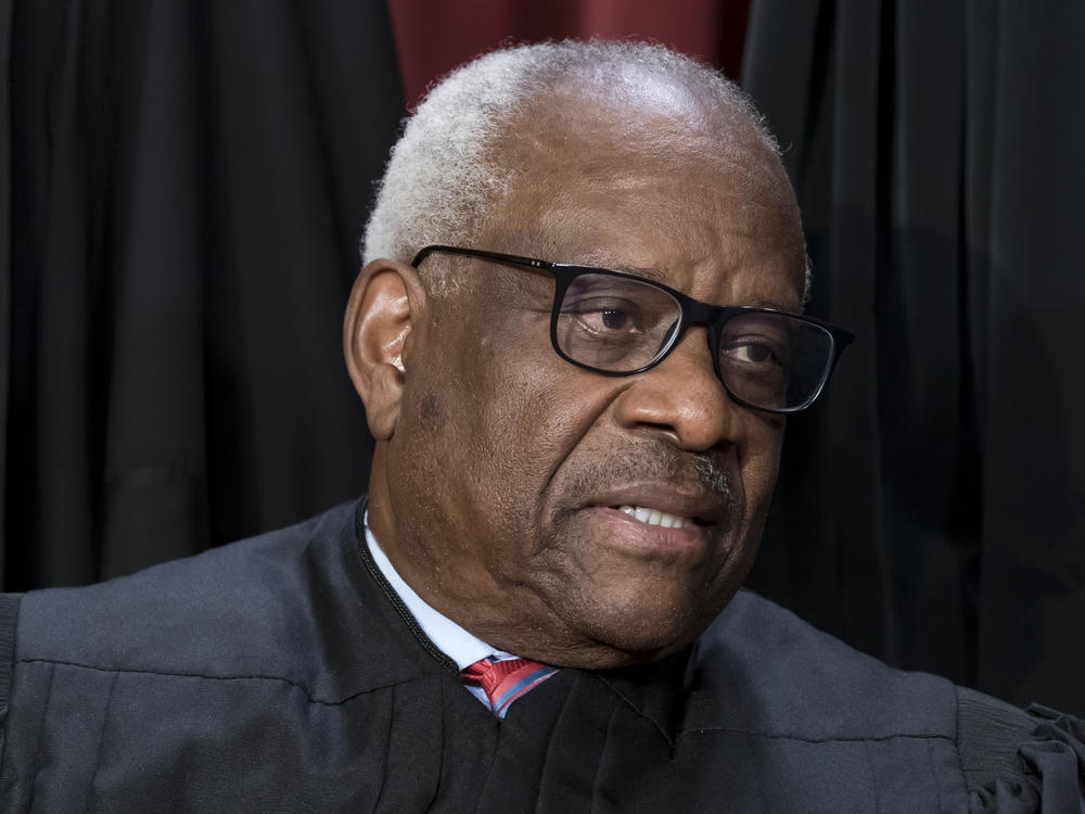 Justice Clarence Thomas joins other members of the Supreme Court as they pose for a new group portrait, at the Supreme Court building in Washington, Friday, Oct. 7, 2022.