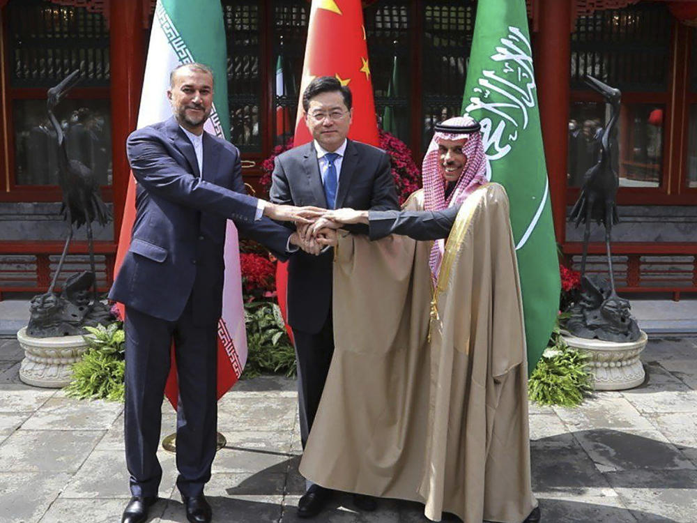 In this picture released by the Iranian Foreign Ministry, Iran's Foreign Minister Hossein Amirabdollahian, left, shakes hands with his Saudi Arabian counterpart Prince Faisal bin Farhan Al Saud, right, and Chineses counterpart Qin Gang in Beijing Thursday, April 6, 2023.