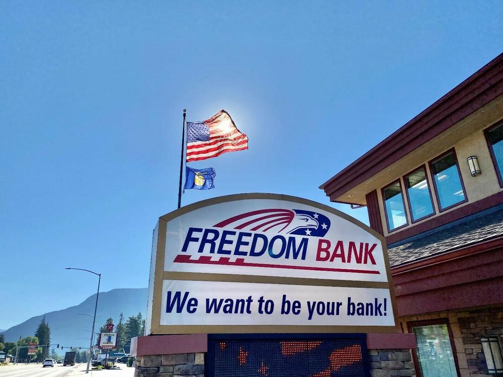 A sign is displayed for Freedom Bank in Columbia Falls, Mont. The community lender was founded over two decades ago and has grown its business by catering to locals. Its CEO, Don Bennett, says they should not be on the hook for recovering the cost of rescuing two failed banks.