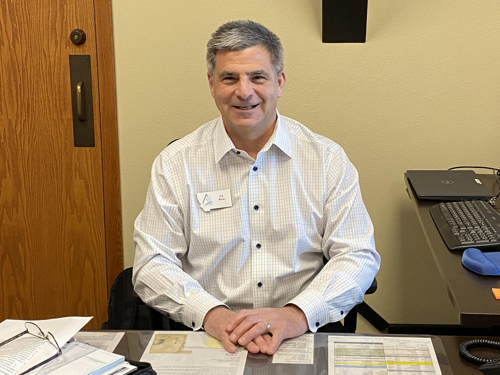 A.J. King, the CEO of Three Rivers Bank in Kalispell, Mont., sitting at his office. King says his bank shouldn't have to pay for mismanagement at Silicon Valley Bank and Signature Bank.