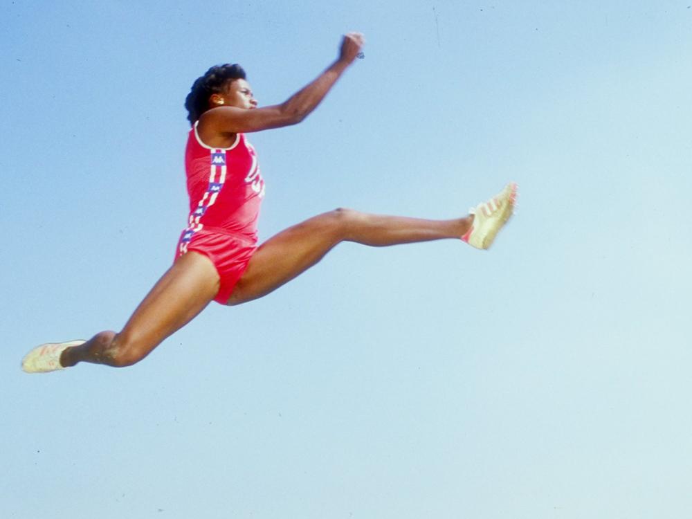 Jackie Joyner-Kersee, performing one of her famous long jumps in 1985.
