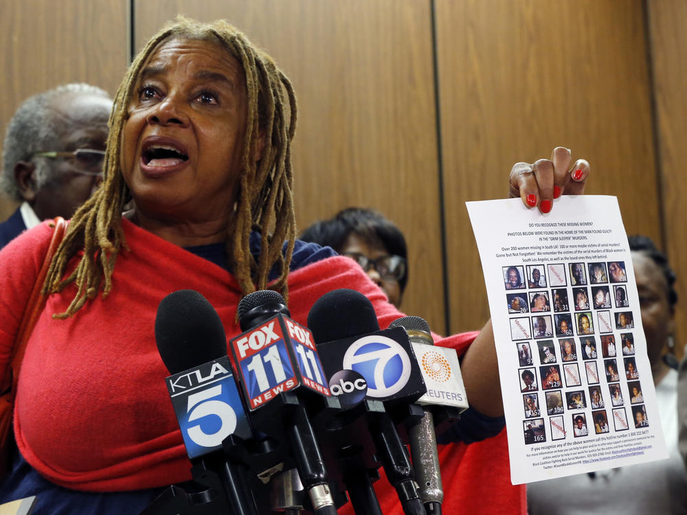 Margaret Prescod, founding member of the Black Coalition Fighting Back Serial Murders, holds a page of photos of missing women, as she joins relatives of victims speaking after the sentencing of Lonnie Franklin Jr., a convicted serial killer known as the 