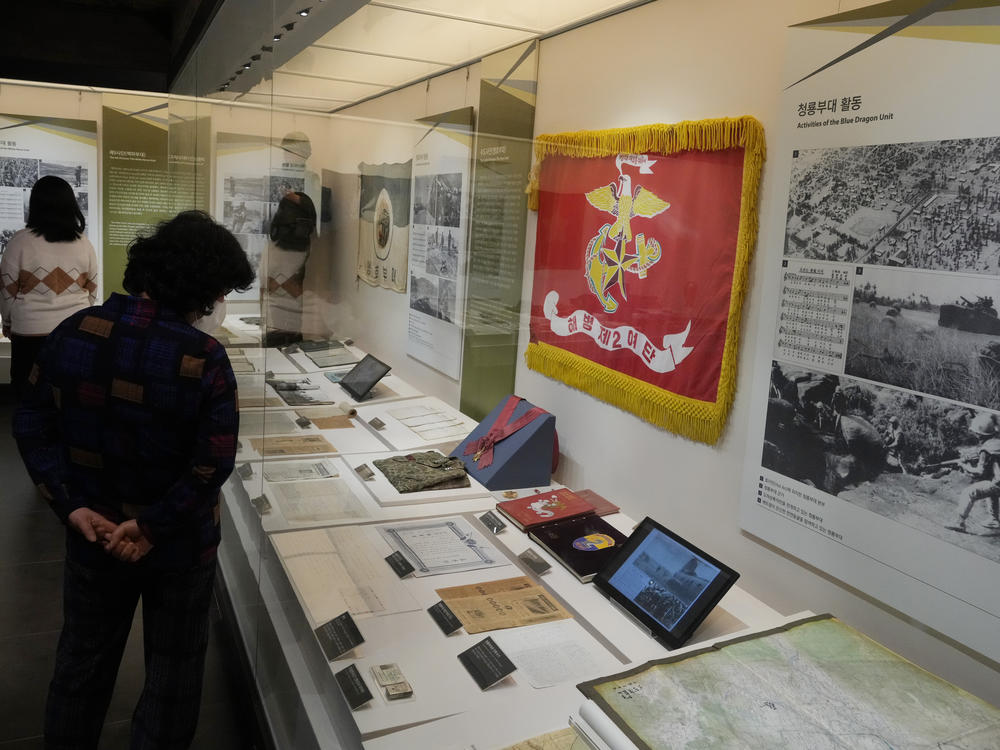 Visitors look at an exhibition of South Korean soldiers' records from the Vietnam War at the War Memorial of Korea in Seoul, Feb. 17.