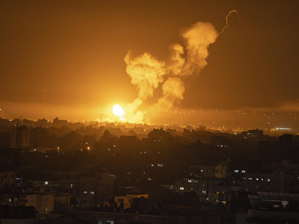 Fire and smoke rise following an Israeli airstrike in central Gaza Strip, Friday, April 7, 2023.