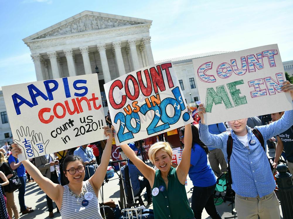 Demonstrators hold signs about counting Asian Americans and Pacific Islanders in the U.S. census during a 2019 protest outside the Supreme Court in Washington, D.C., against the failed push to add a citizenship question by former President Donald Trump's administration.
