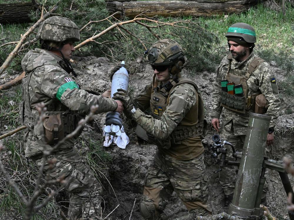 Ukrainian troops prepare to fire a mortar toward Russian positions on the frontline in the eastern region of Donetsk on Wednesday.