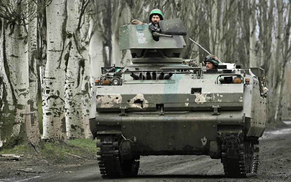Ukrainian troops ride in an armored personnel carrier near the eastern Ukrainian town of Bakhmut, the scene of heavy fighting, on April 6.