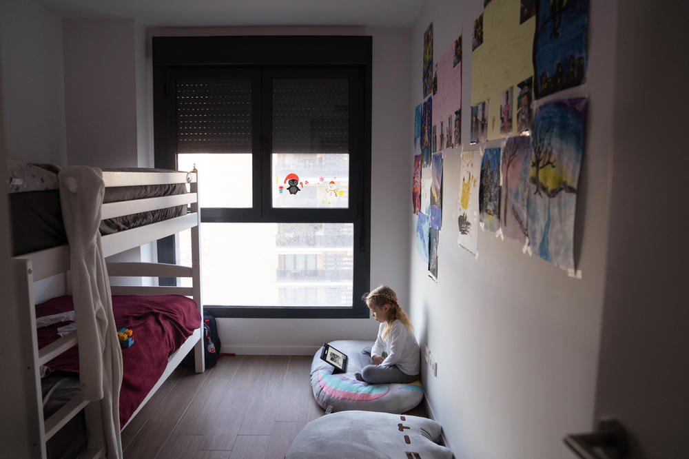 Aurora takes a virtual Spanish lesson in the bedroom she shares with her brother.