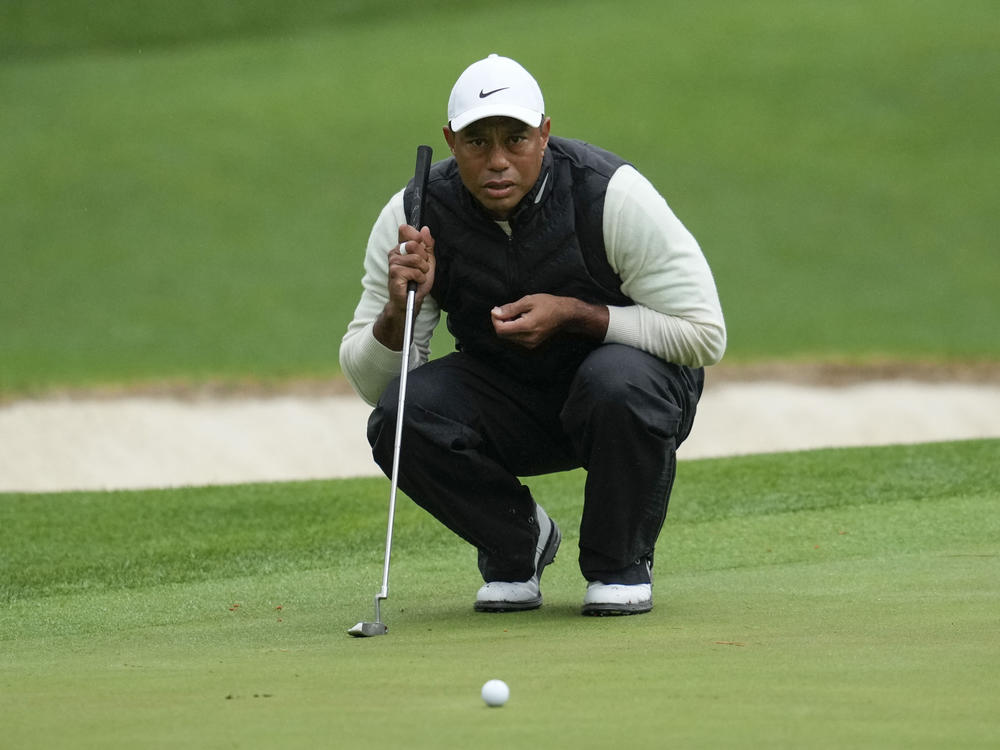 Tiger Woods lines up a putt on the 16th hole during the weather-delayed second round of the Masters golf tournament at Augusta National Golf Club on Saturday, April 8, 2023, in Augusta, Ga.