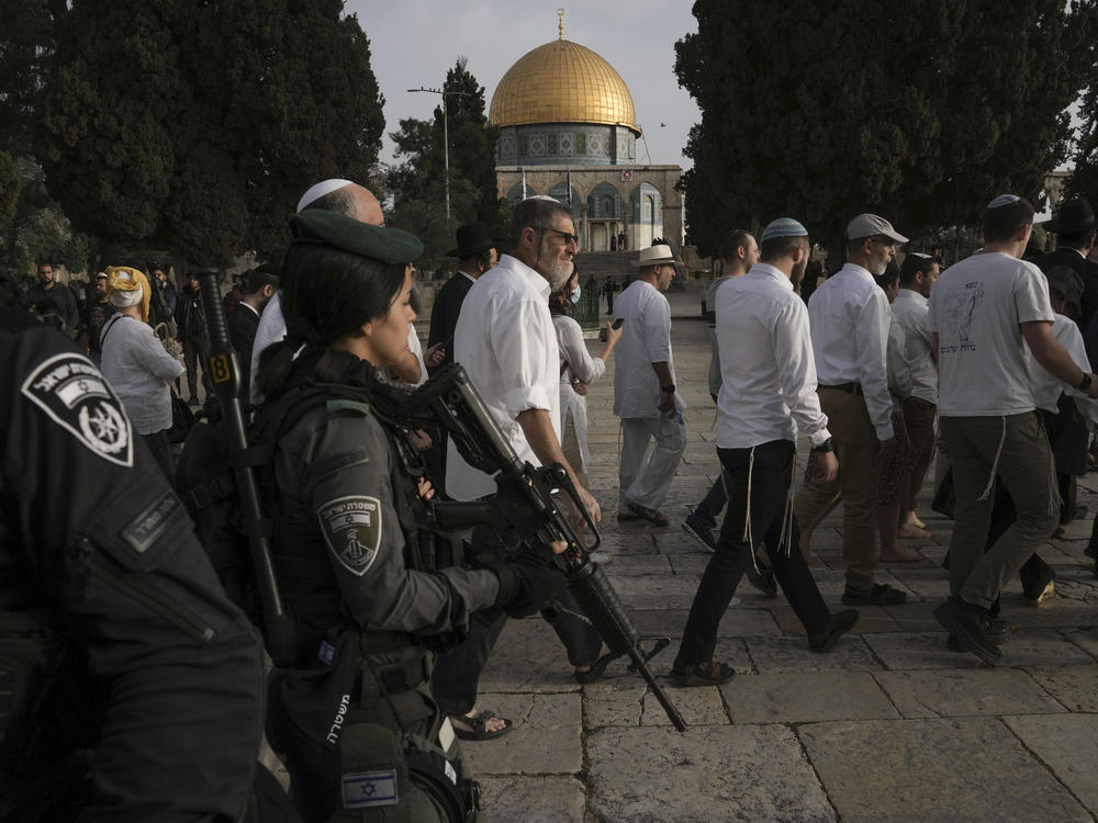 Israeli police escort Jewish visitors marking the holiday of Passover to the Al-Aqsa Mosque compound, known to Muslims as the Noble Sanctuary and to Jews as the Temple Mount, in the Old City of Jerusalem during the Muslim holy month of Ramadan on Sunday, April 9, 2023.