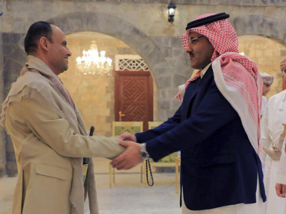 In this handout photo released on April 9, 2023 by the Houthi group's media arm Ansar Allah, head of the Houthi's supreme political council Mahdi al-Mashat, left, shakes hands with Saudi Arabia's Ambassador to Yemen Mohammed bin Saeed Al-Jaber, in Sanaa, Yemen.