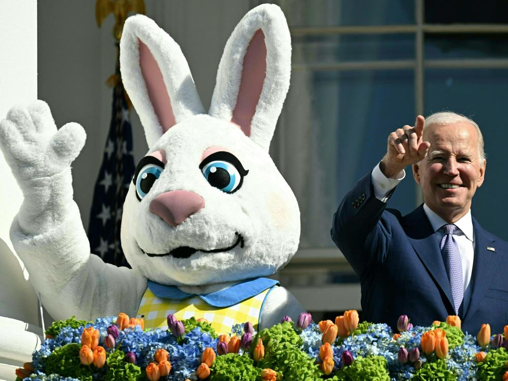 President Biden, alongside the Easter Bunny (L), gestures after speaking at the annual Easter Egg Roll.