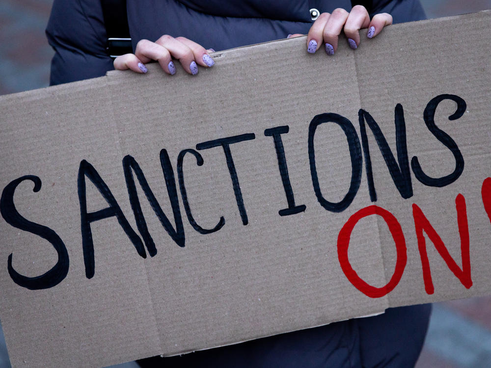 KYIV, UKRAINE - FEBRUARY 21: A group of people hold signs at the front of the Ukrainian Foreign Ministry during a protest calling for the European Union to impose additional sanctions against Russia on February 21, 2022 in Kyiv, Ukraine.