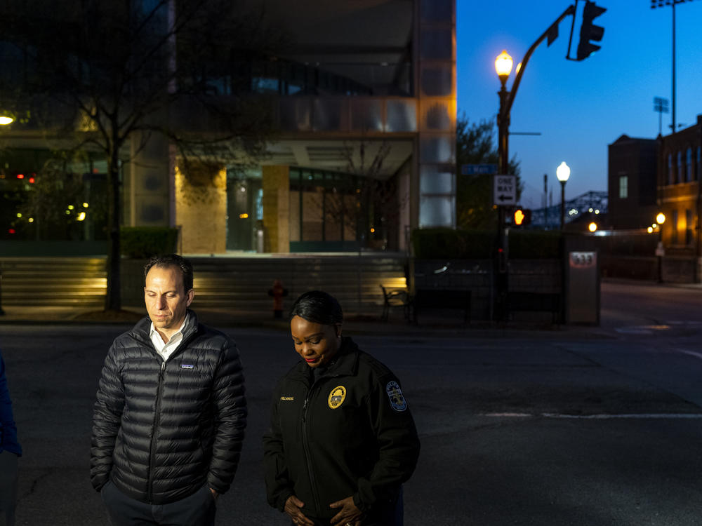 Louisville Mayor Craig Greenberg and interim Police Chief Jacquelyn Gwinn-Villaroel stand outside of Louisville's Old National Bank on Tuesday for interviews in Louisville.