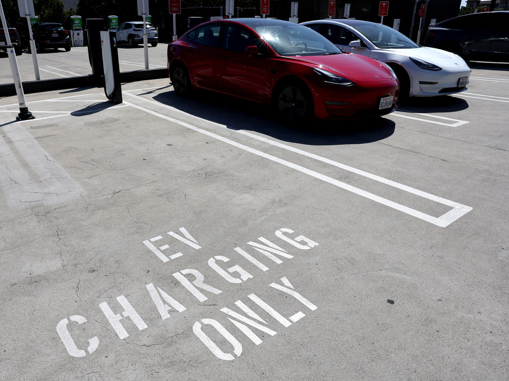 Tesla cars recharge at a Tesla Supercharger station in Pasadena, Calif., on April 14, 2022. The pivot to electric cars depends not only on the automakers ability to produce these cars. It also depends on building the infrastructure needed to support having more electric cars on the roads.