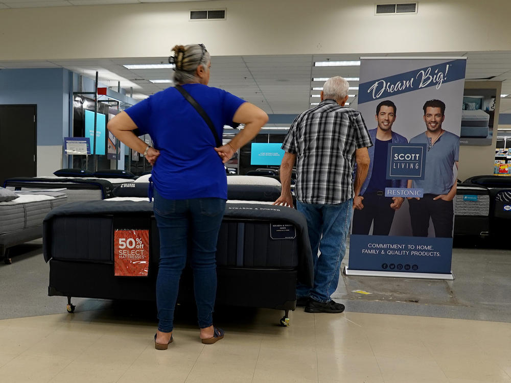 Shoppers look over mattresses at a store in Miami on March 14, 2023.