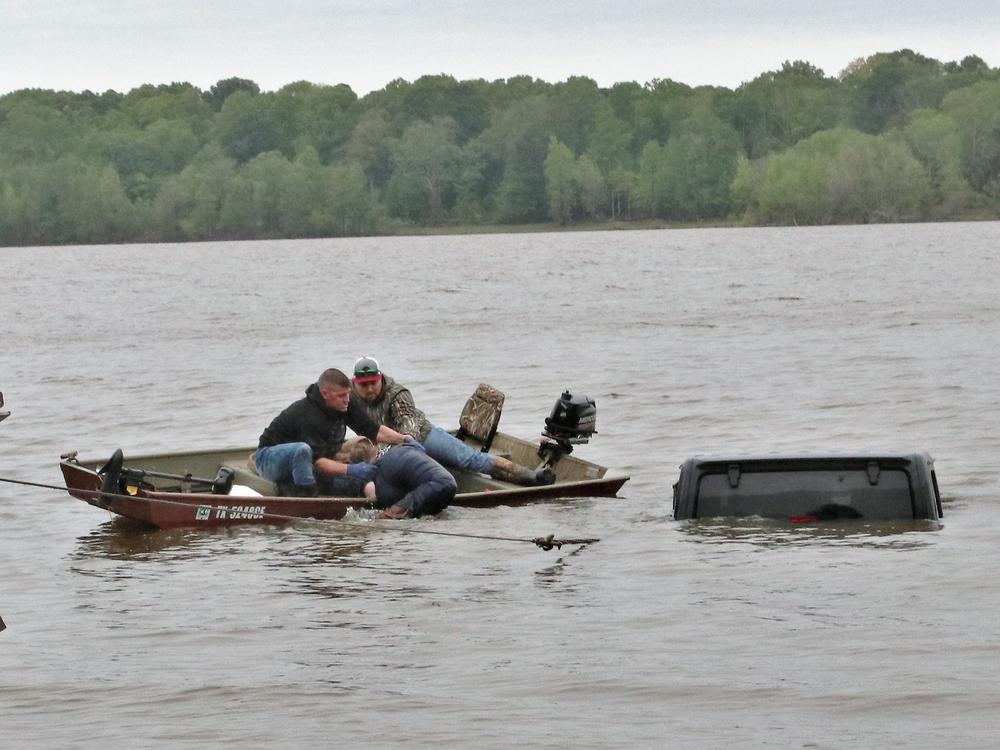After being discovered in a Jeep, a woman was pulled out of the vehicle and into a fishing boat. Police in a nearby town say she had been reported missing hours earlier.