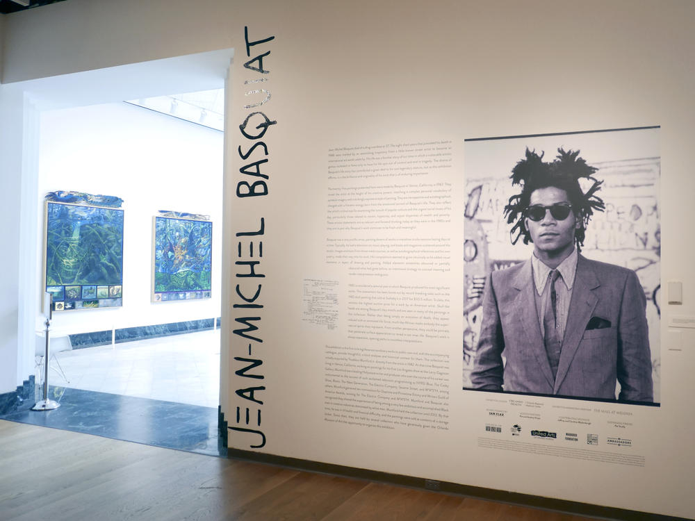 The entrance to an exhibit by artist Jean-Michel Basquiat is seen at the Orlando Museum of Art on June 1, 2022, in Orlando, Fla. A former Los Angeles auctioneer has pleaded guilty in a cross-country art fraud scheme where he created fake artwork and falsely attributed the paintings to artist Jean-Michel Basquiat.