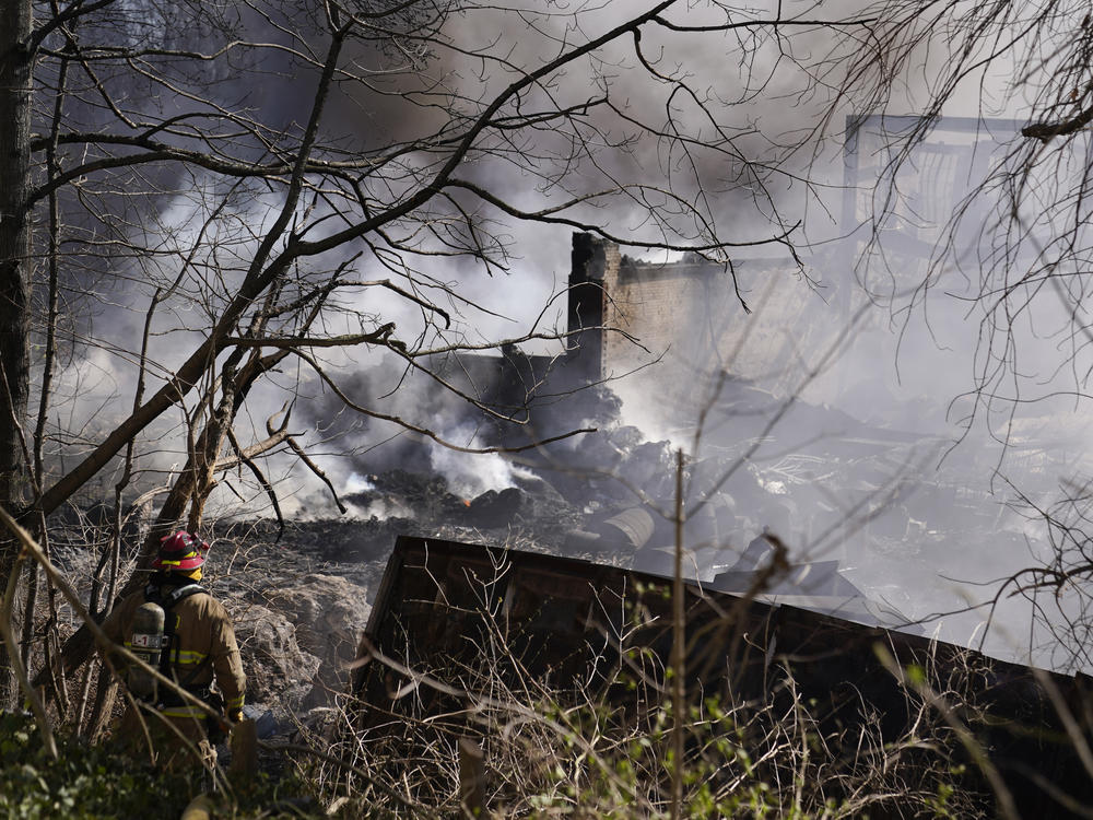Firefighters pour water on an industrial fire in Richmond on Wednesday.