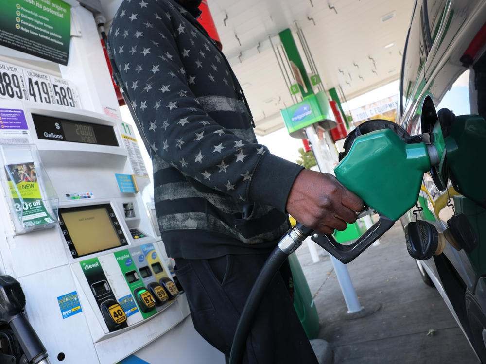 A person prepares to pump gas at a BP gas station in Brooklyn, New York City, on Oct. 19, 2022. Americans could save between $580 billion and $1.1 trillion on gasoline under the EPA's proposed auto emission regulations, according to the agency.
