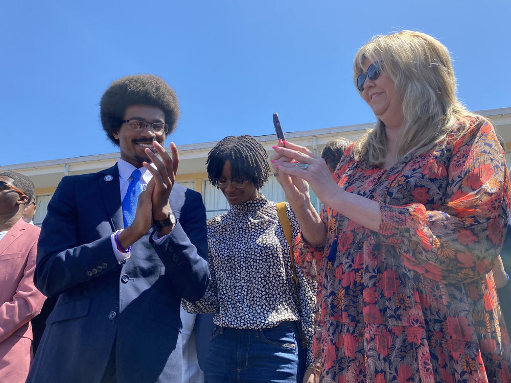 Justin J. Pearson stands with state Rep. Gloria Johnson during a rally in Memphis, Tenn., before a vote to reinstate him to the Tennessee House on Wednesday.
