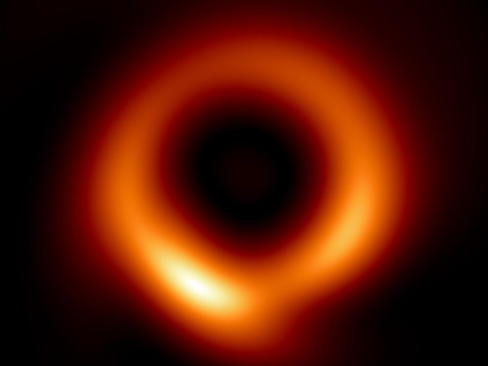 Researchers used computer simulations of black holes and machine learning to generate a revised version (right) of the famous first image of a black hole that was released back in 2019 (left).