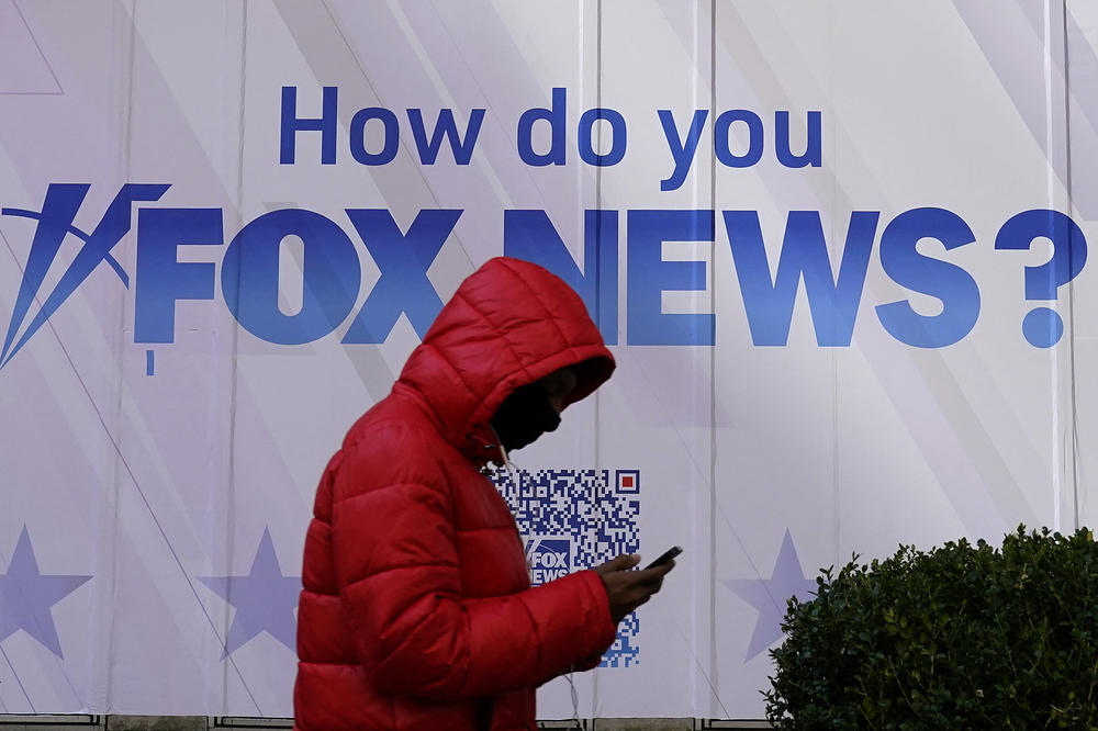 A person walks past the Fox News headquarters at the News Corporation building in New York City last month. Dominion Voting Systems is suing Fox News and parent company Fox Corp. over election fraud claims that Fox aired in 2020 and 2021.