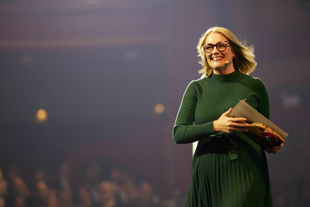 Debbie Rogers, CEO of Reach Digital Health, leaves the stage at the Skoll World Forum with her award, presented this week. She explains that her group taps mobile phone technology to 