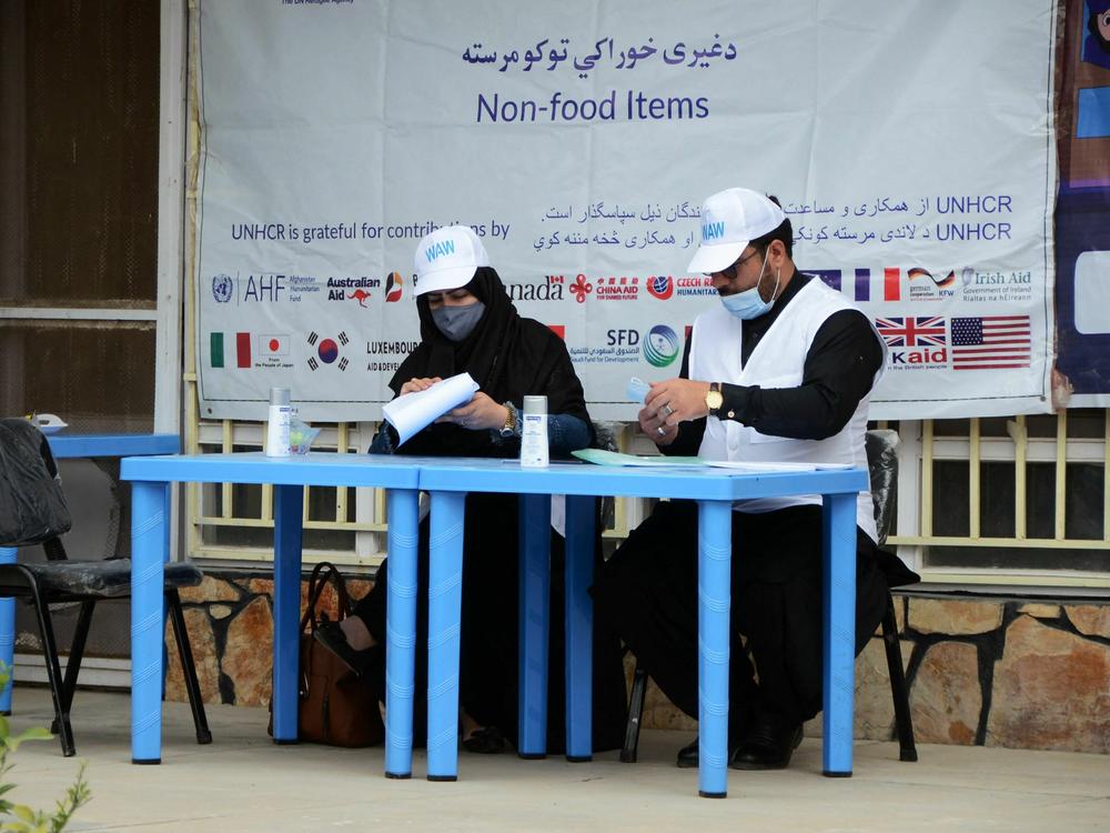 United Nations High Commissioner for Refugees workers prepare to distribute non-food items to women at UNHCR office in Kandahar on March 8, 2022. The Taliban has demanded that Afghan women no longer work for the UN or NGOs.