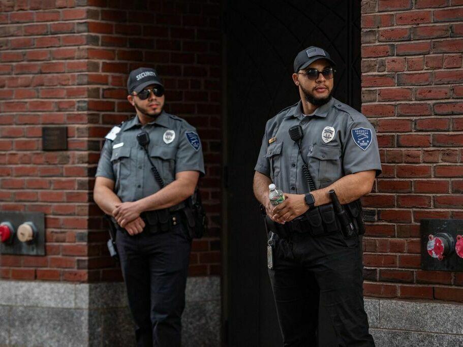 Security guards stand outside the entrance to the John Joseph Moakley United States Courthouse in Boston on Friday. Jack Teixeira, 21, an employee of the U.S. Air Force National Guard, appeared at the federal court Friday.