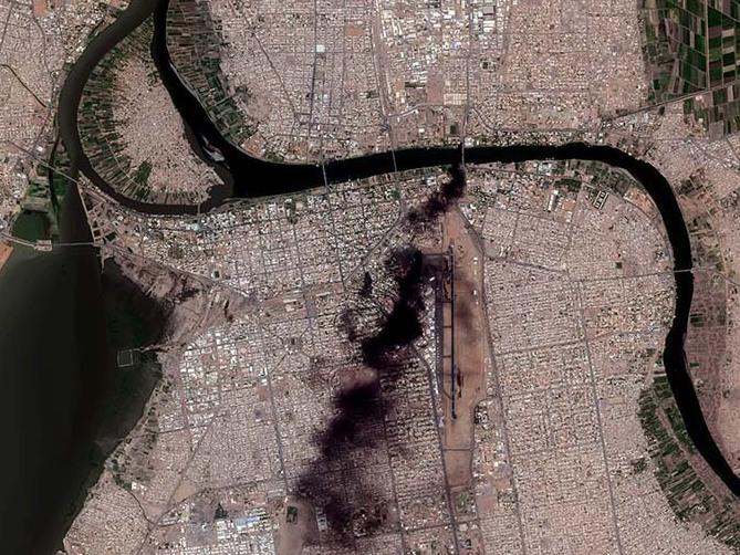 Satellite image shows thick, black smoke drifting across the city at multiple locations an overview of fires burning in Khartoum on Sunday.