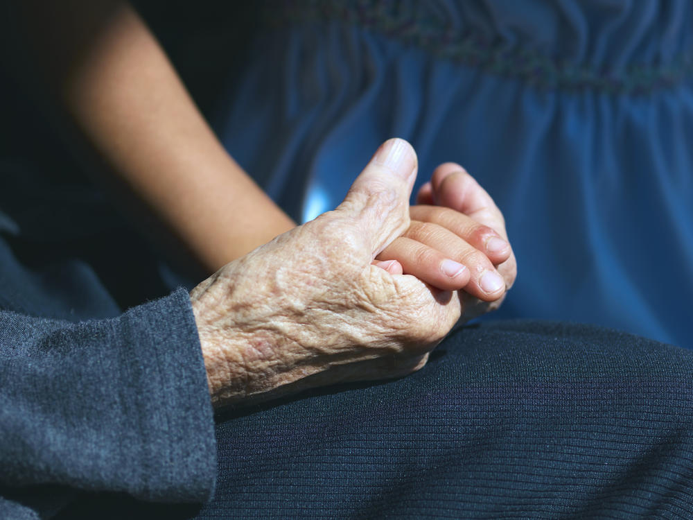 A girl holding her great-grandmother's hand. Japan has one of the world's most rapidly aging societies.