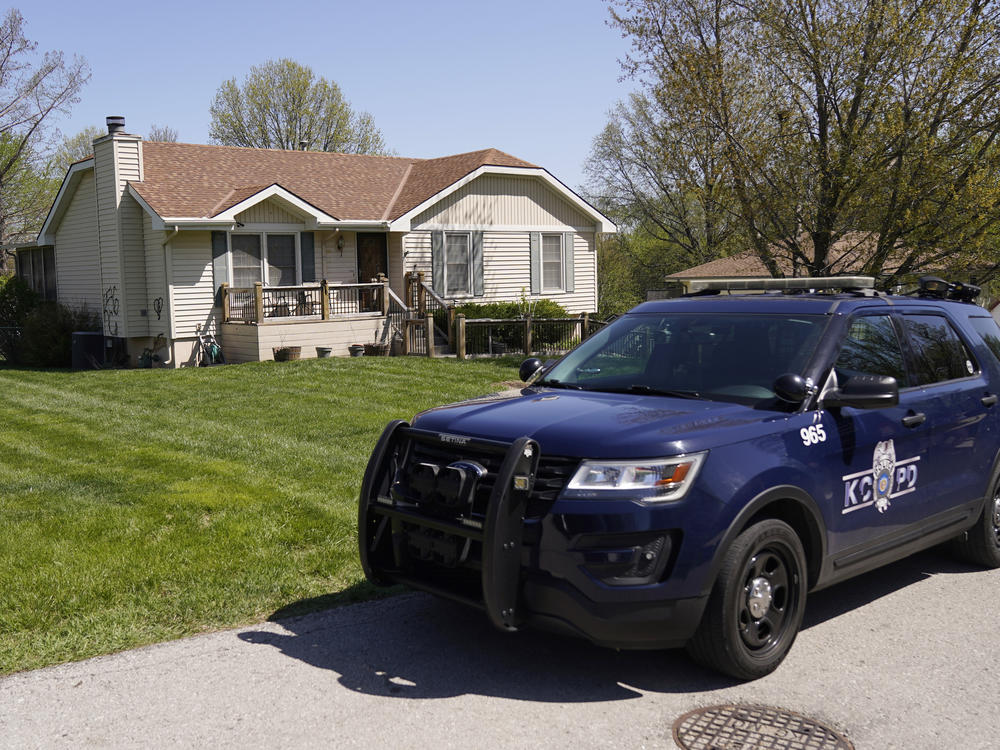 A police officer drives past the Kansas City home where 16-year-old Ralph Yarl was shot last week.