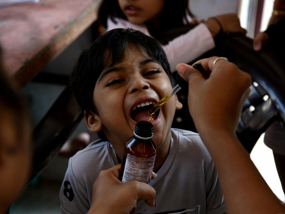 A health worker administers a measles vaccine during a vaccination drive, prompted by a measles outbreak, in Navi Mumbai, India, in December 2022. A new UNICEF report finds that India has the world's largest number of children with zero doses of childhood vaccines: 2.7 million