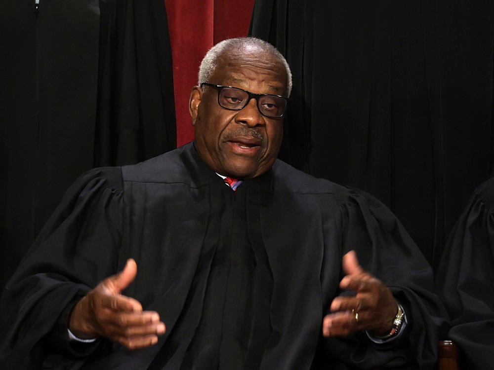 Supreme Court Justice Clarence Thomas poses with Justice Sonia Sotomayor and Chief Justice John Roberts pose for their official portrait in 2022.
