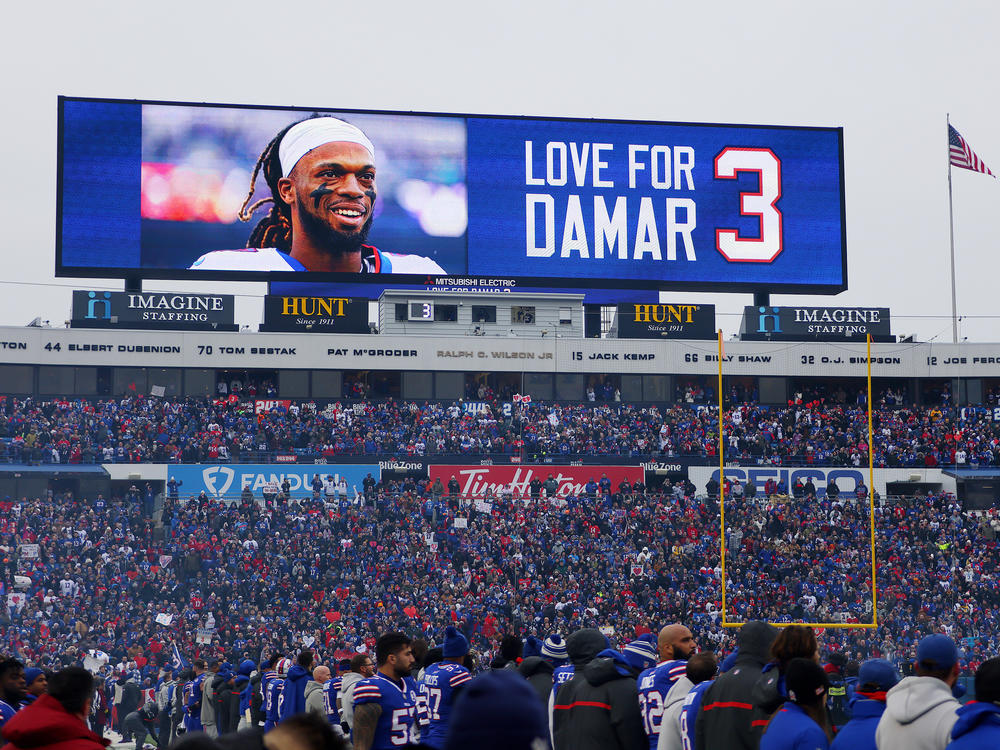 A scoreboard shows a message of support for Damar Hamlin at a January Bills-Patriots game in New York. The Bills' general manager says Hamlin has been cleared to play.