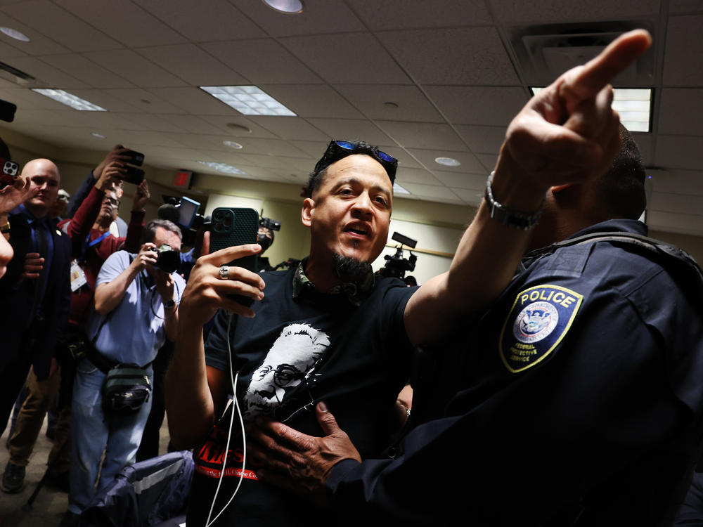 A critic of Manhattan District Attorney Alvin Bragg is led out of the room by police during a House Judiciary Committee field hearing on violent crime in New York on Monday.