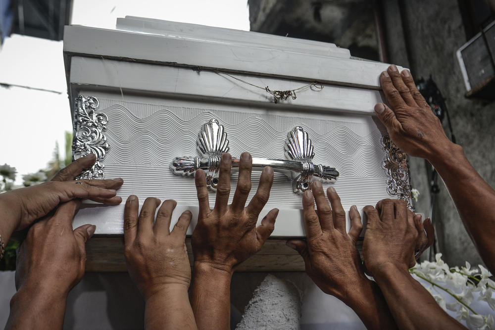 Relatives and friends carry the coffin of Kian Loyd Delos Santos during his funeral in Caloocan, Metro Manila, Philippines, Aug. 26, 2017.