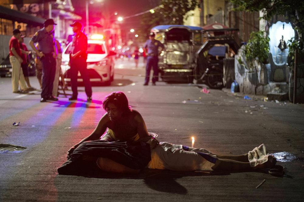 Nanette Castillo grieves next to the dead body of her son Aldrin, an alleged drug user killed by unidentified assailants, in Manila, Oct. 3, 2017.