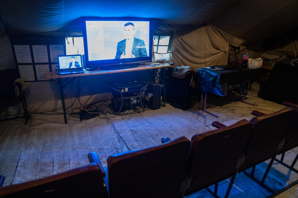 A TV plays in the warming tent in Saltivka.