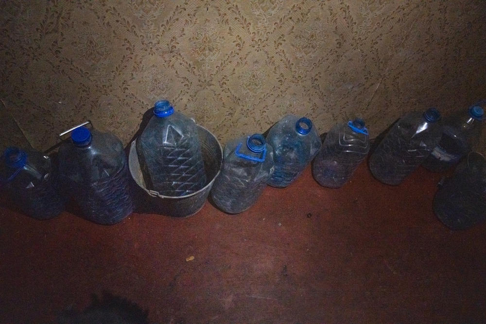 Empty plastic bottles line the hallway of the apartment in Saltivka. With no running water, people have to bring in their own fresh water.