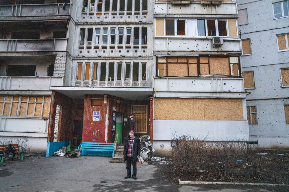 Dudnik stands outside the building where he lives in Saltivka.
