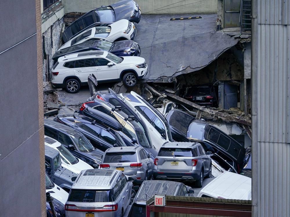 Cars are seen piled on top of each other at the scene of a partial collapse of a parking garage in the Financial District of New York, Tuesday, April 18, 2023, in New York.