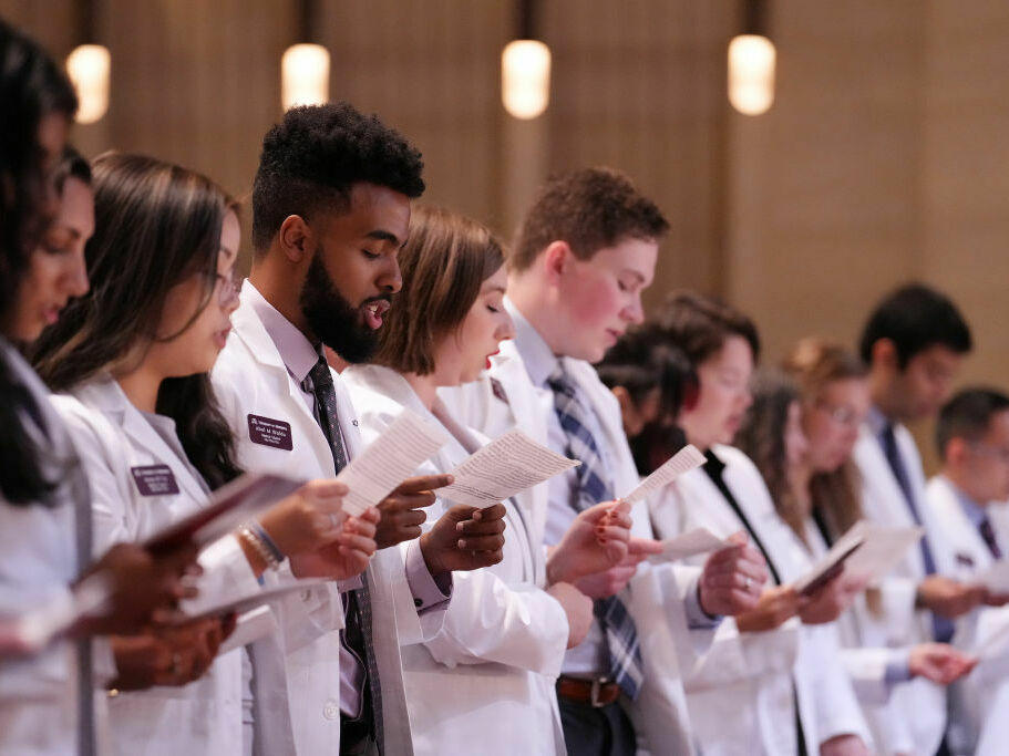 Students at the University of Minnesota celebrate their induction into medical school. The U.S. has disproportionately few Black and Hispanic doctors. Some of the barriers to entering the profession start before even getting into medical school, recent research finds, including financial pressures and racism.