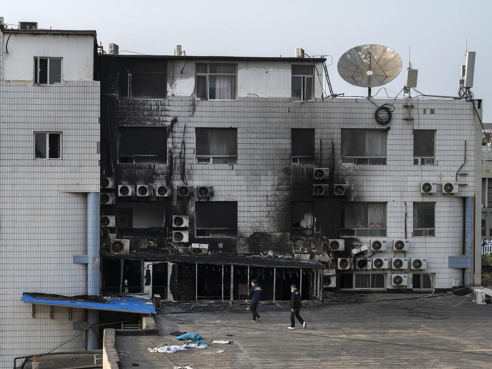 Fire investigators inspect the scene of a deadly fire at the Changfeng Hospital in the Fengtai District on Wednesday in Beijing. At least 29 people died in the fire on Tuesday afternoon, and 12 people have been detained for questioning. The cause of the blaze was unknown at the time the photo was taken.